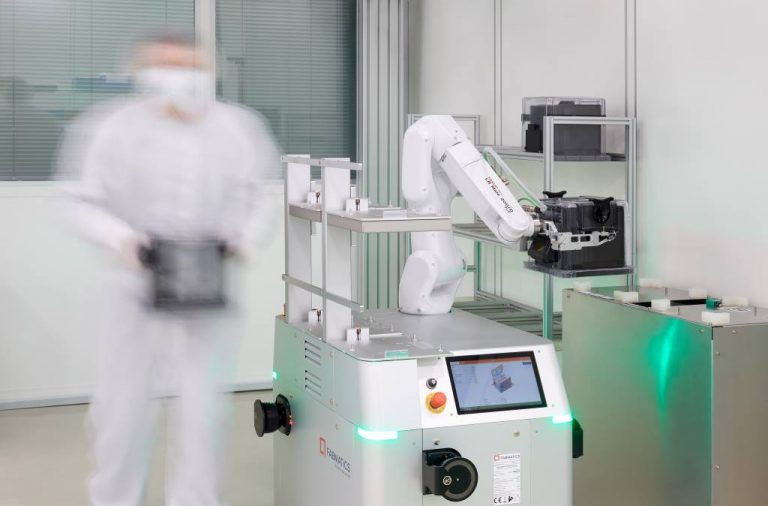 Automated Guided Vehicle (AGV) HERO FAB in the cleanroom handling and transporting wafers together with an operator