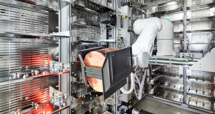 Robotic arm handling a foup with wafers in a storage unit