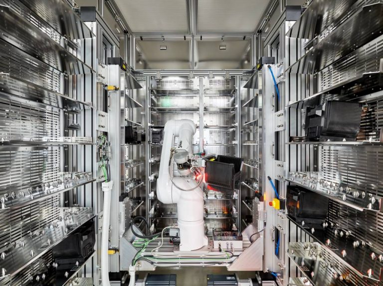 Interior of the robot portal of the CubeStocker with a view of the 6-axis robot handling a wafer cassette.